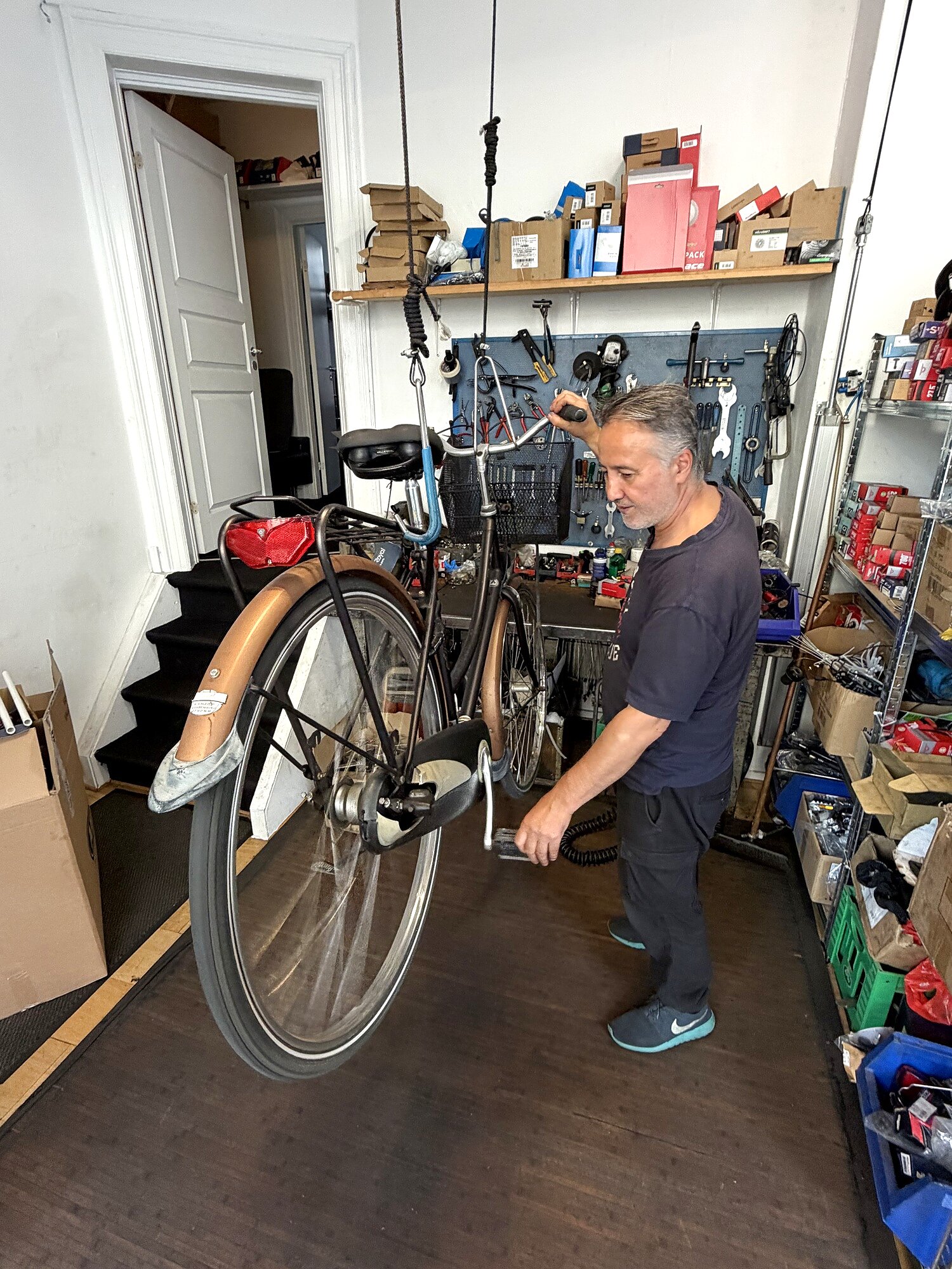 Bike mechanic Ramazan working on a bike in the workshop