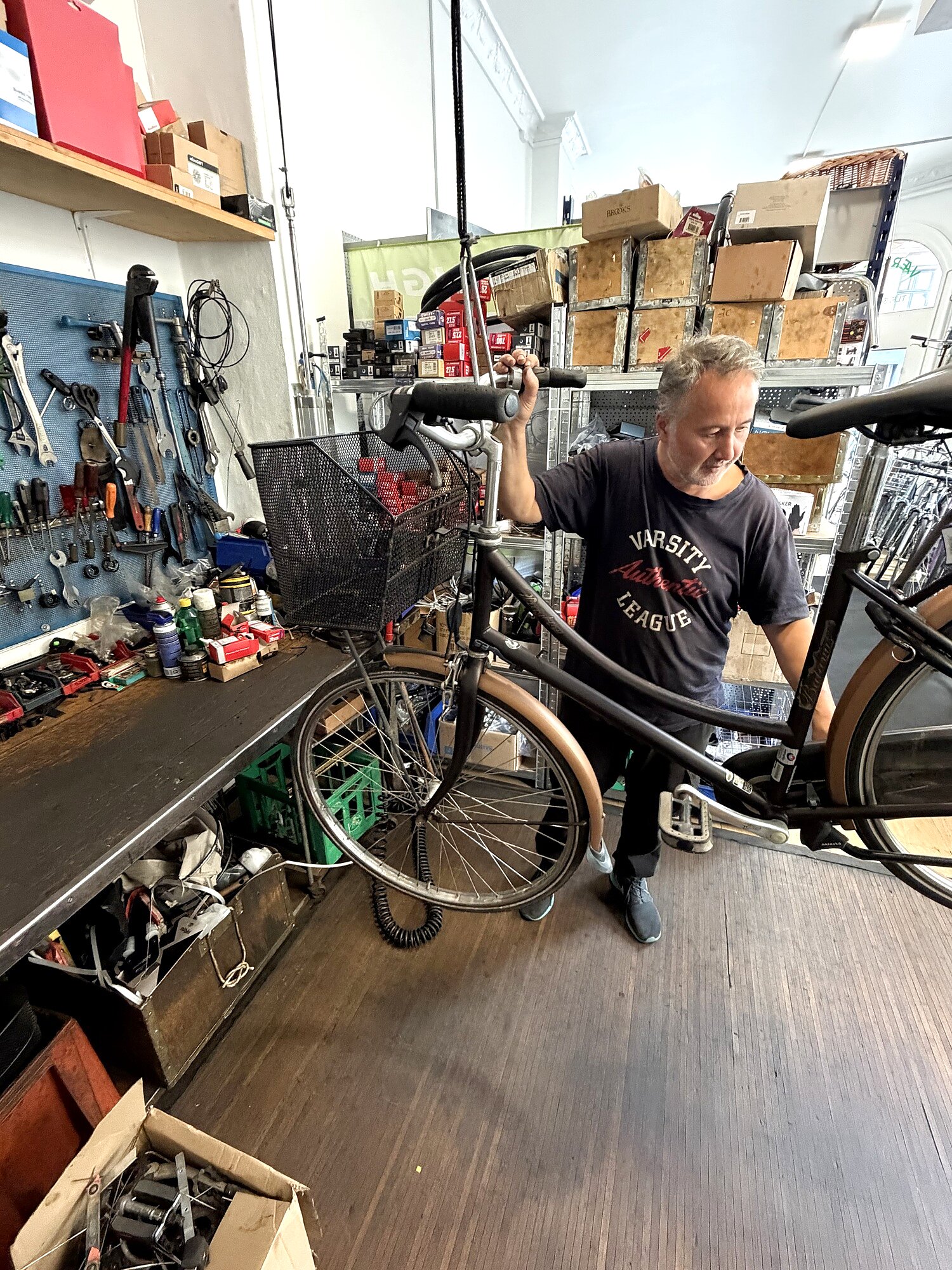 Owner Ramazan repairing a bike in the Le Tour Cykler workshop