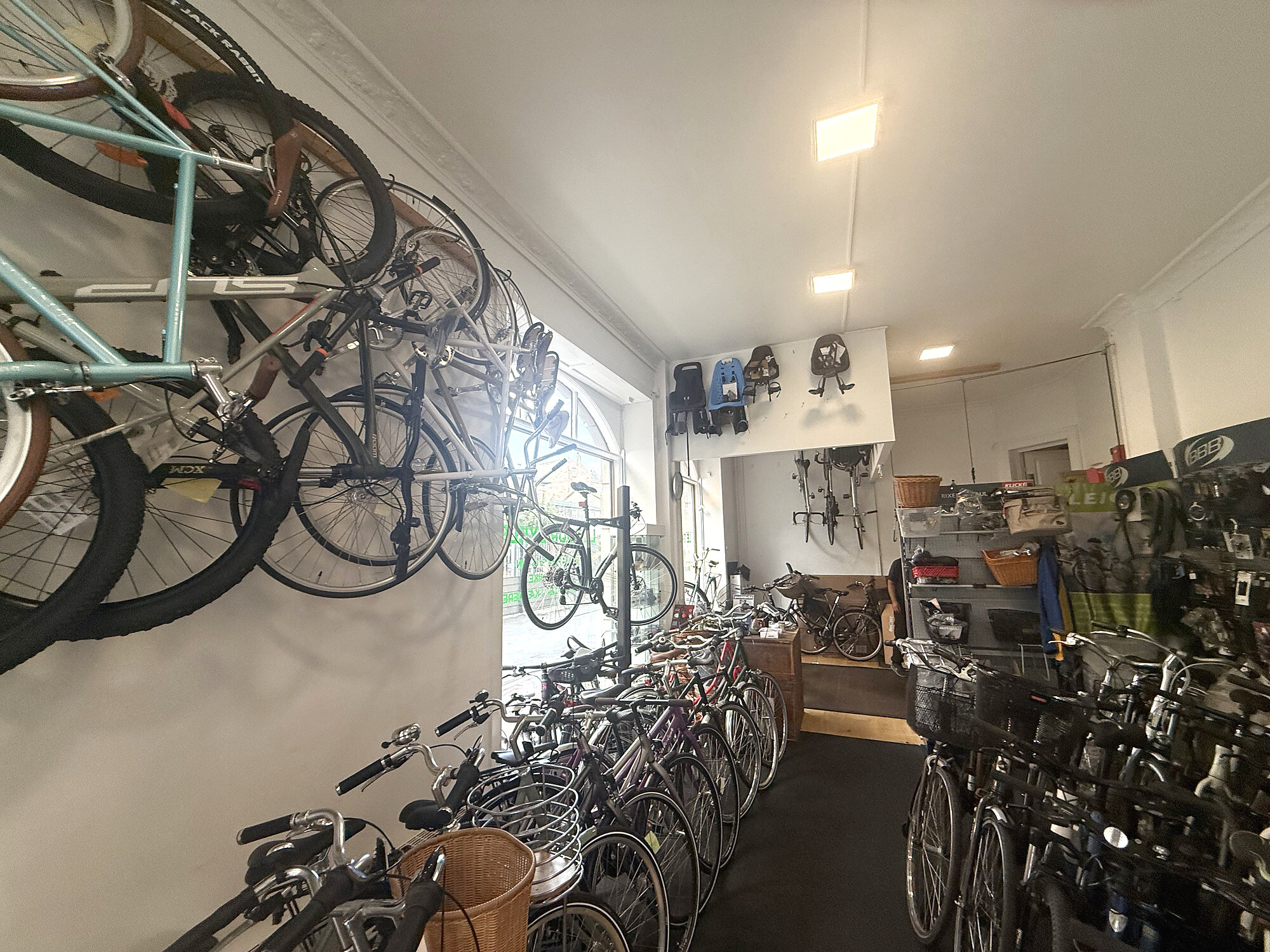 Bikes and child seats inside Le Tour Cykler in Nørrebro